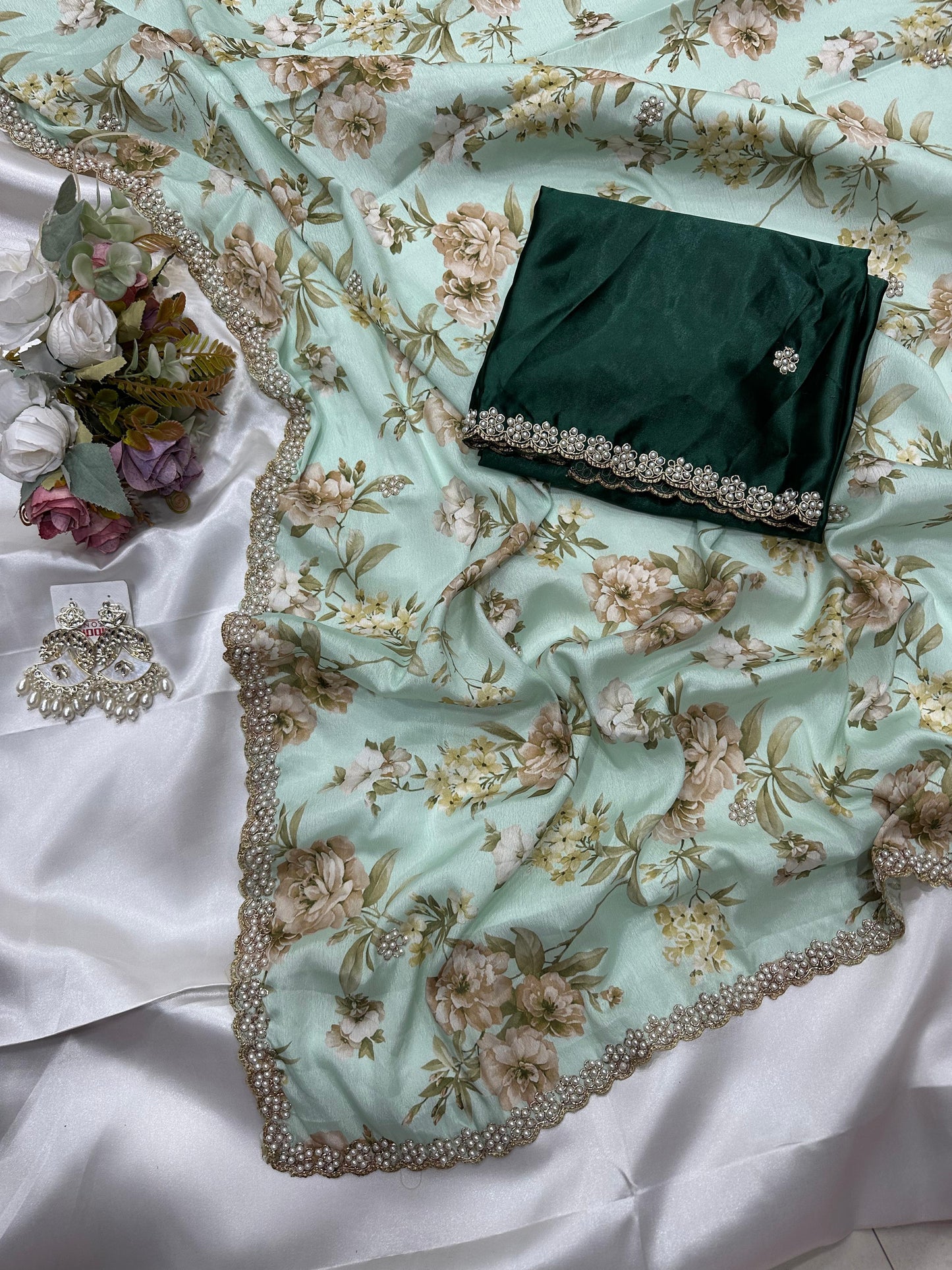 Pastel green floral embroidered chinon saree with a bottle green blouse