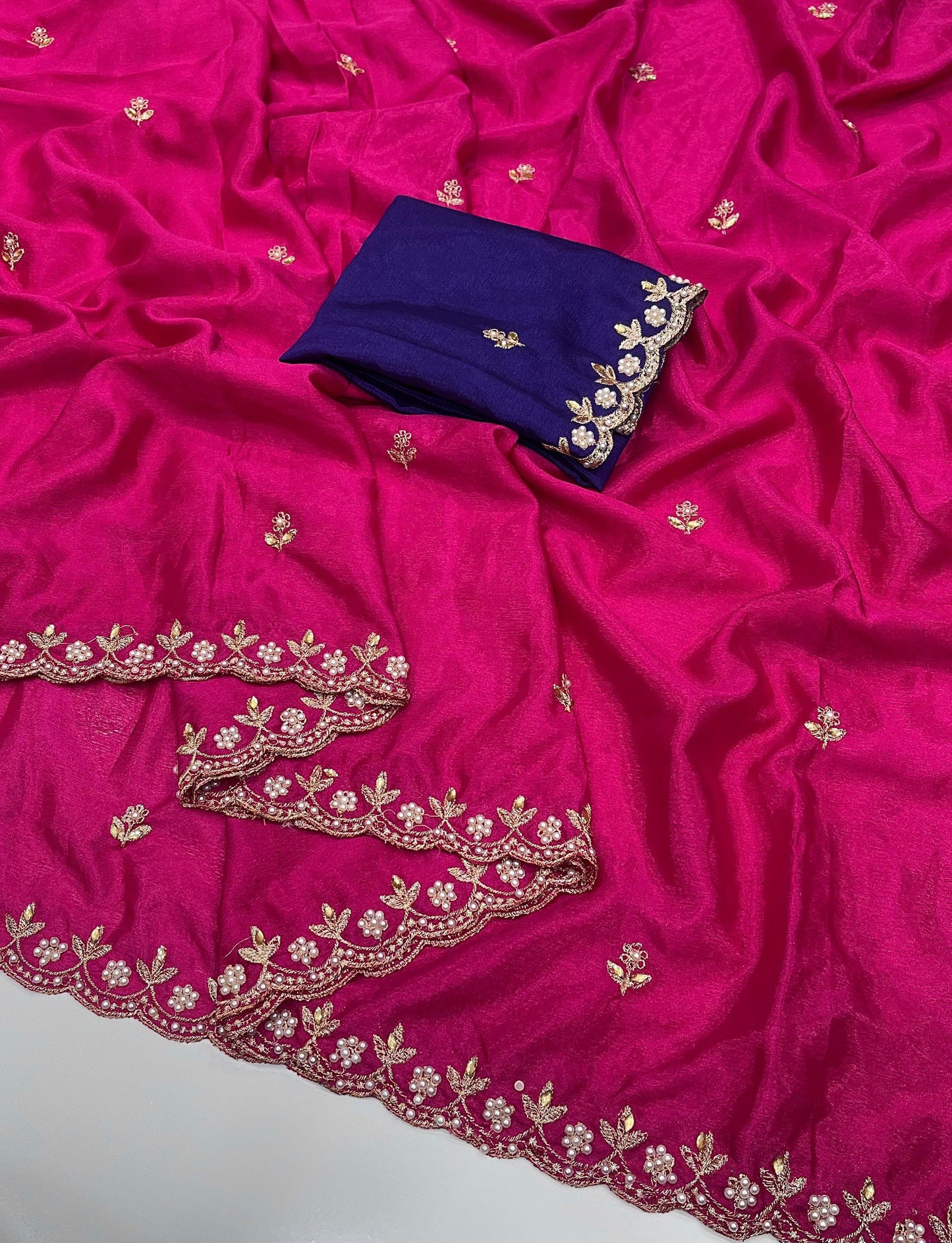 Pink chinon saree with gold embroidery and a purple blouse piece