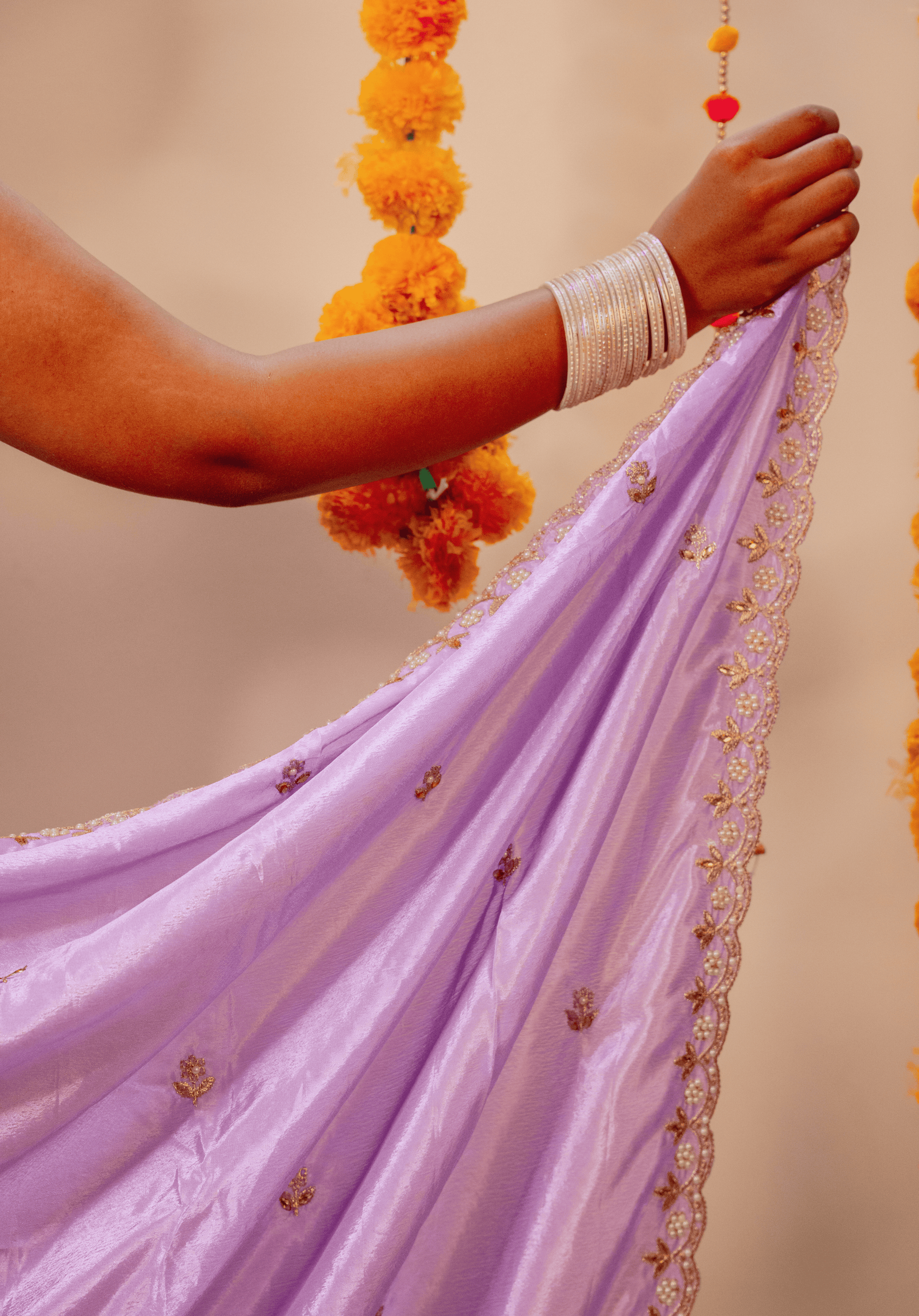 Close up of lilac chinon saree with embroidered border