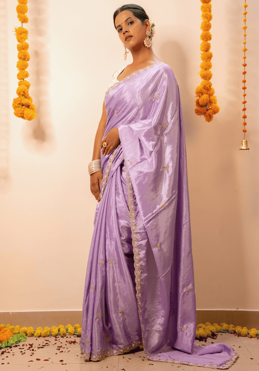 Woman wearing a lilac chinon saree 