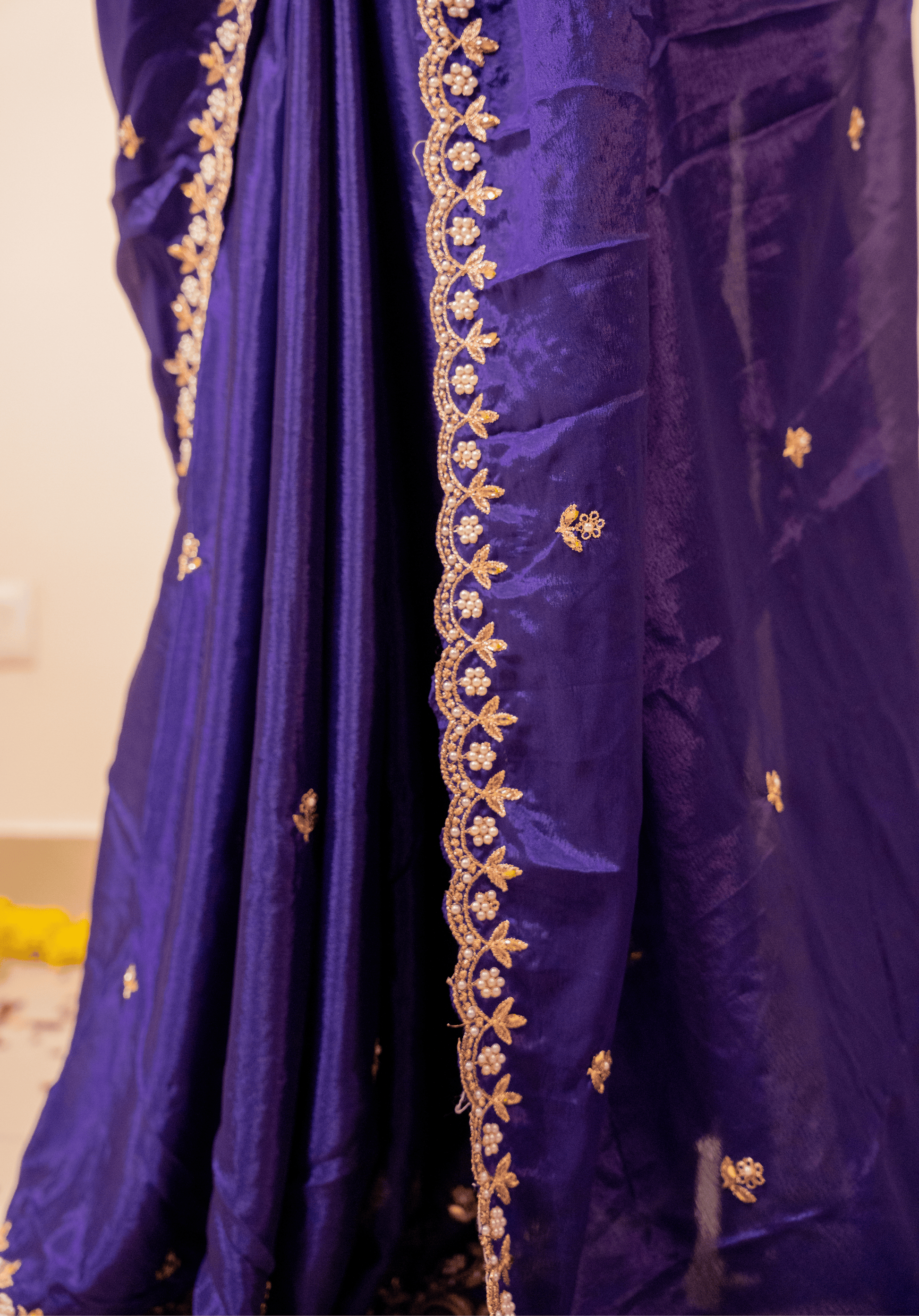 Close-up of a purple chinon saree with gold embroidery