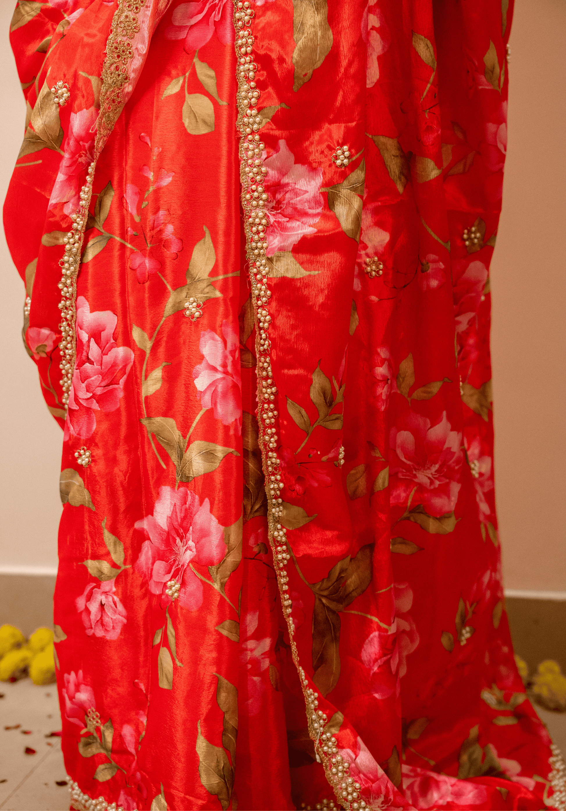 Cherry red floral chinon saree with white and gold embroidery.