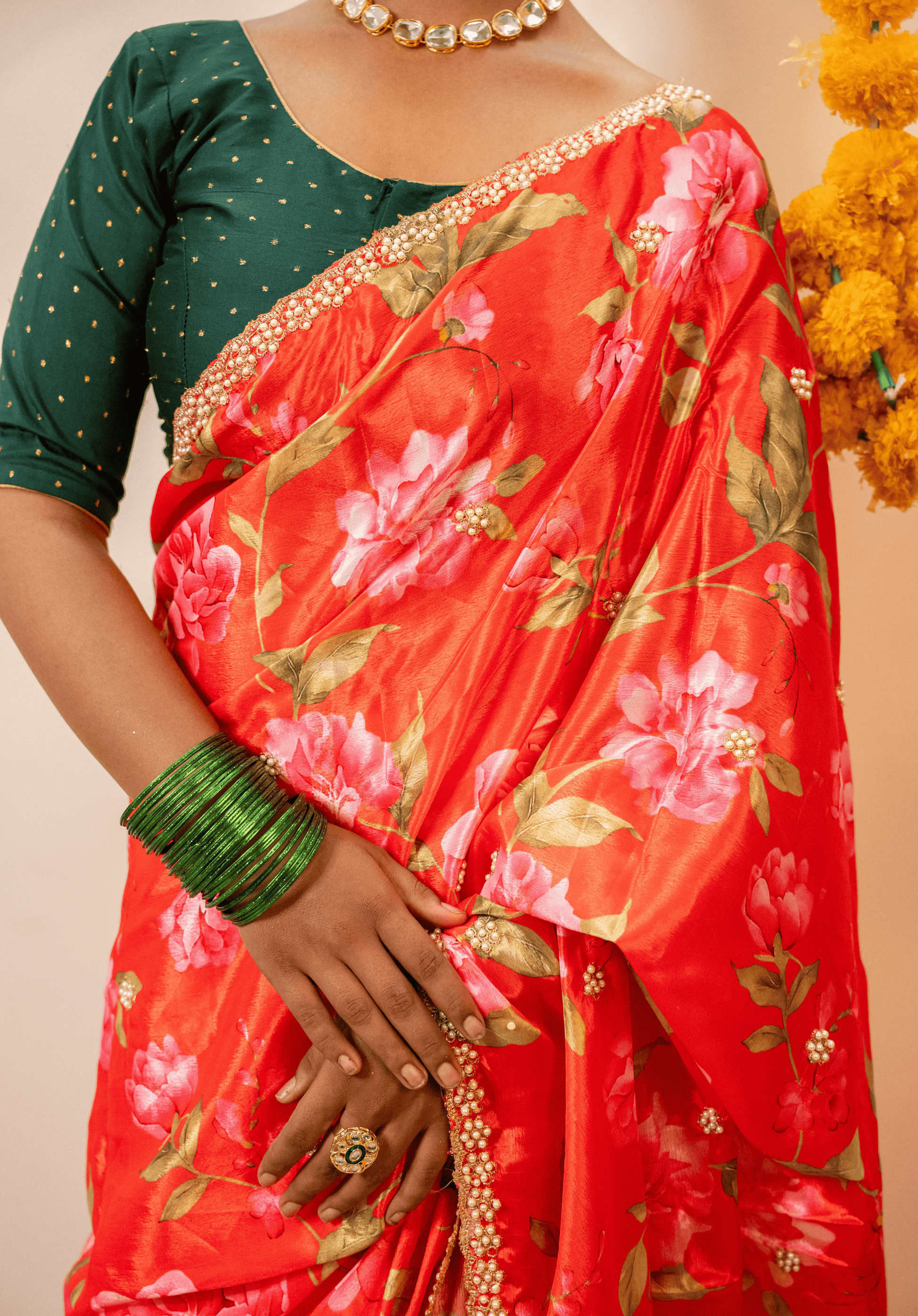 Close up of cherry red floral chinon embroidered saree with green blouse 
