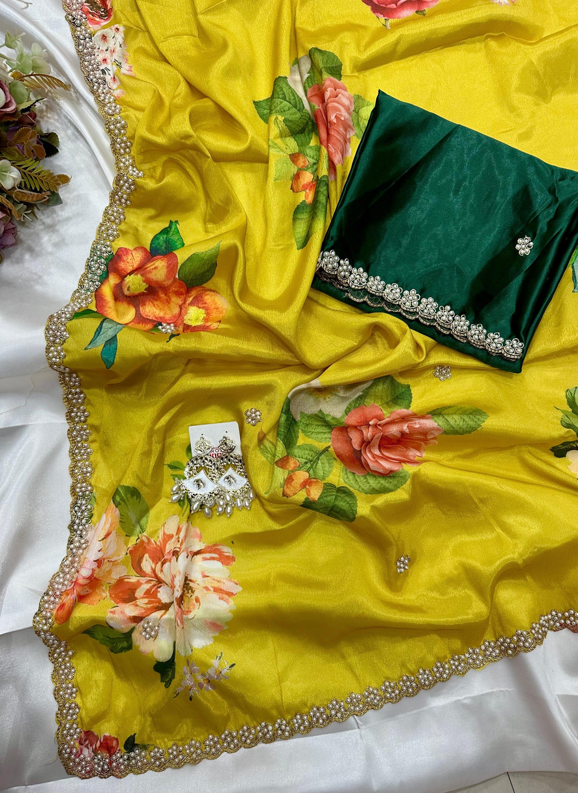 Yellow floral embroidered saree with a green blouse 
