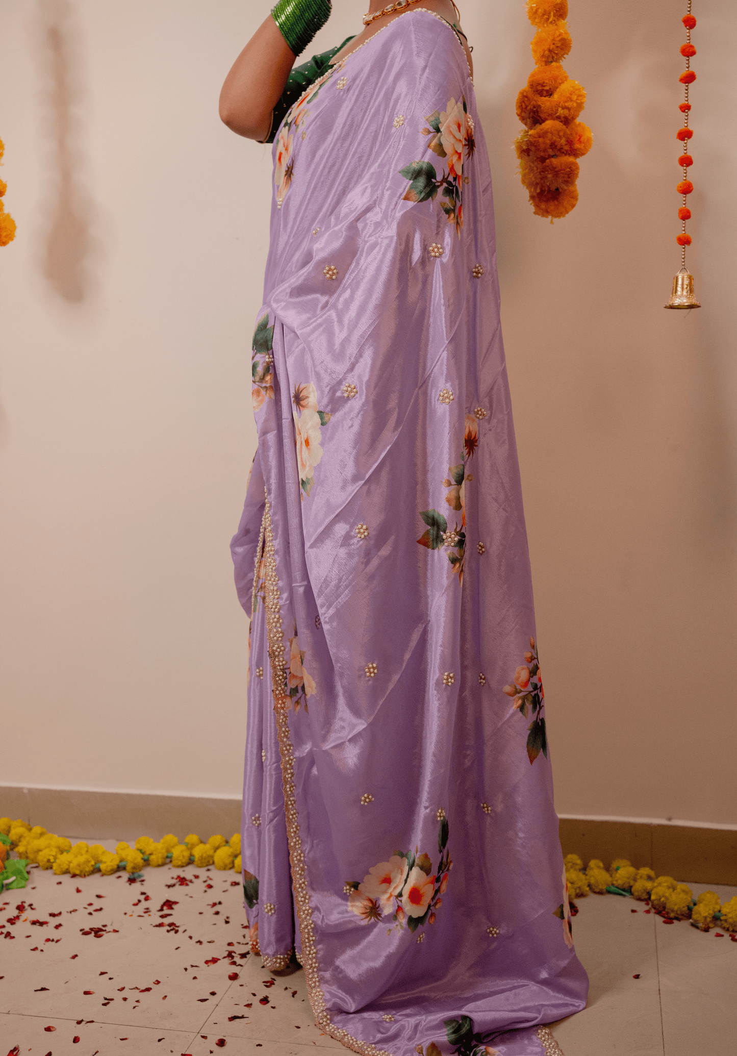 Women wearing a lilac chinon saree with floral patterns.