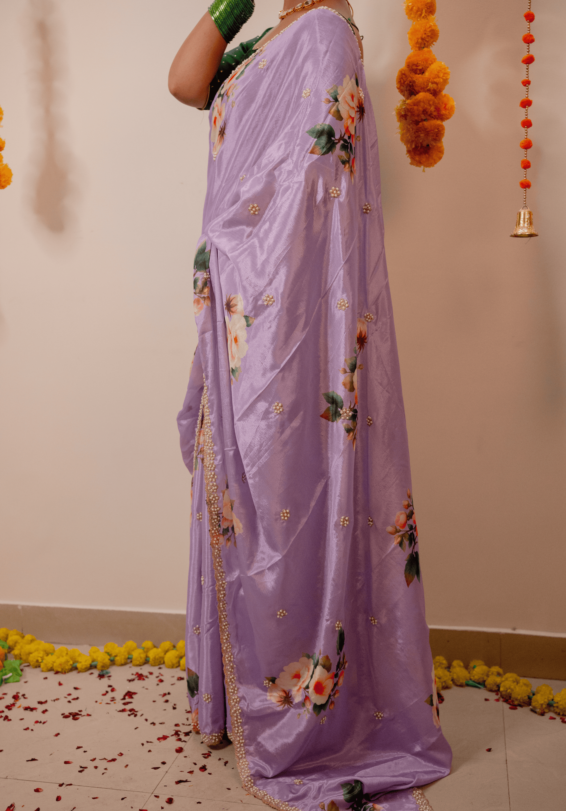Women wearing a lilac chinon saree with floral patterns.