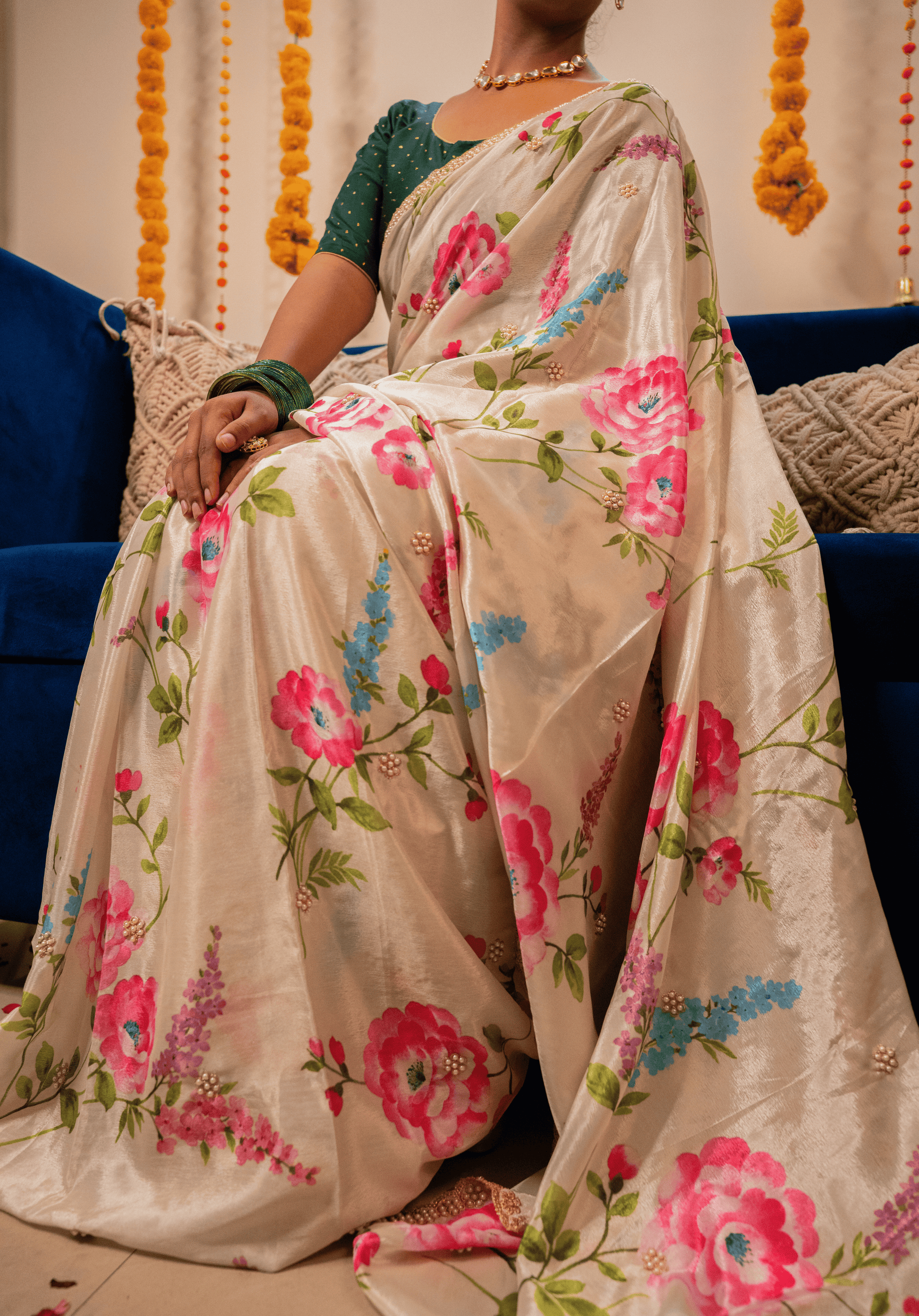 Person wearing an off white floral chinon saree with embroidery
