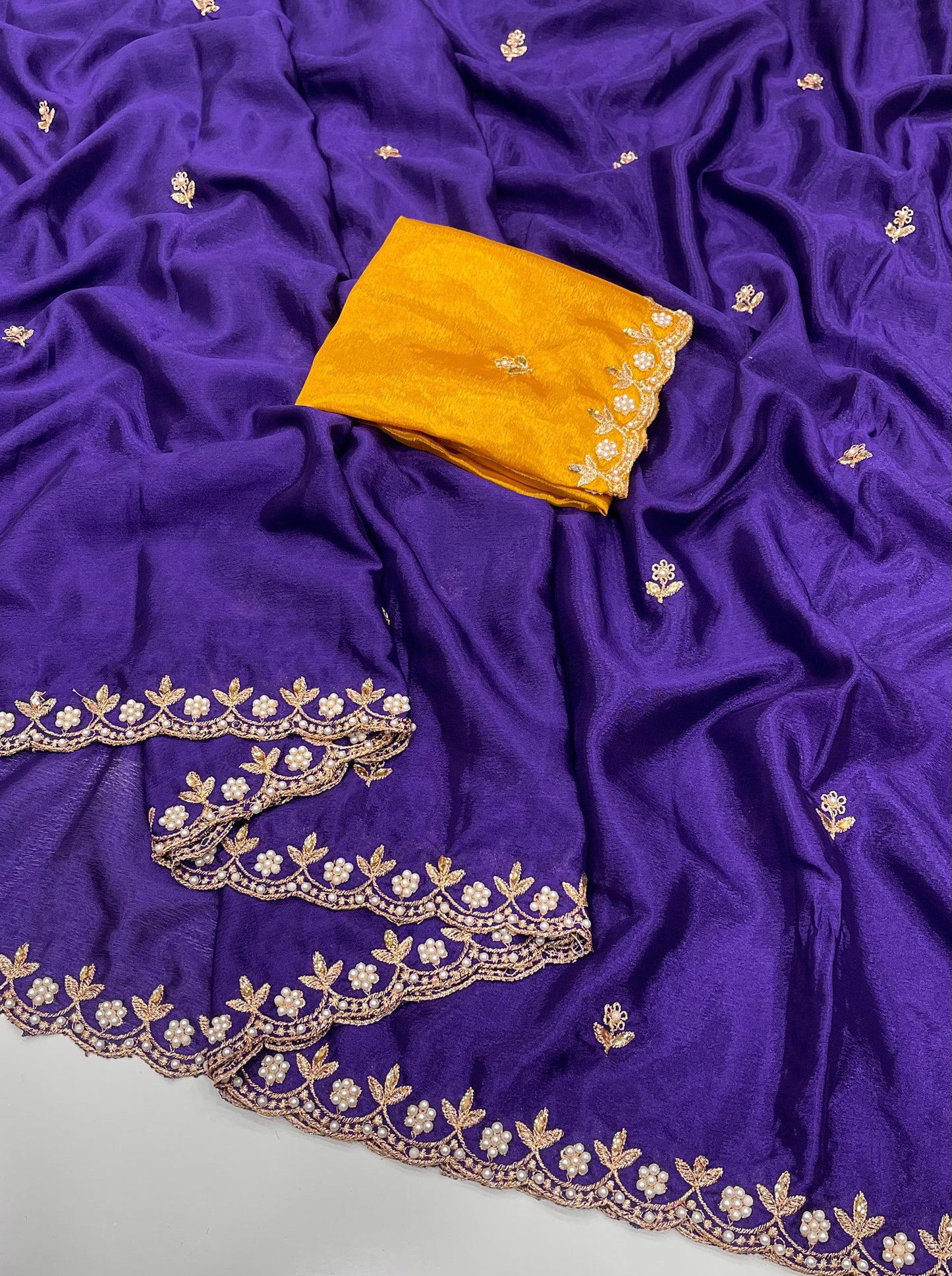 Purple chinon saree with gold embroidery and a yellow blouse piece 